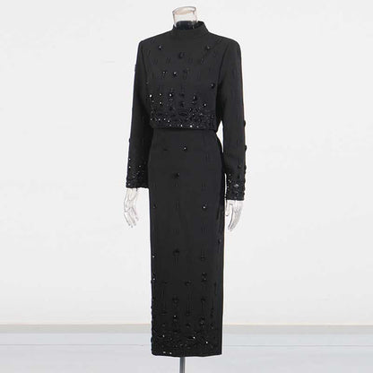 Elegant beaded women's skirt suit in black featuring long sleeves and intricate bead detailing