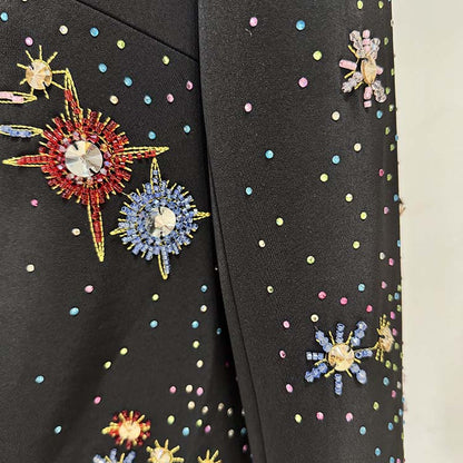 Close-up of black beaded crystal mini dress featuring colorful gemstone embellishments