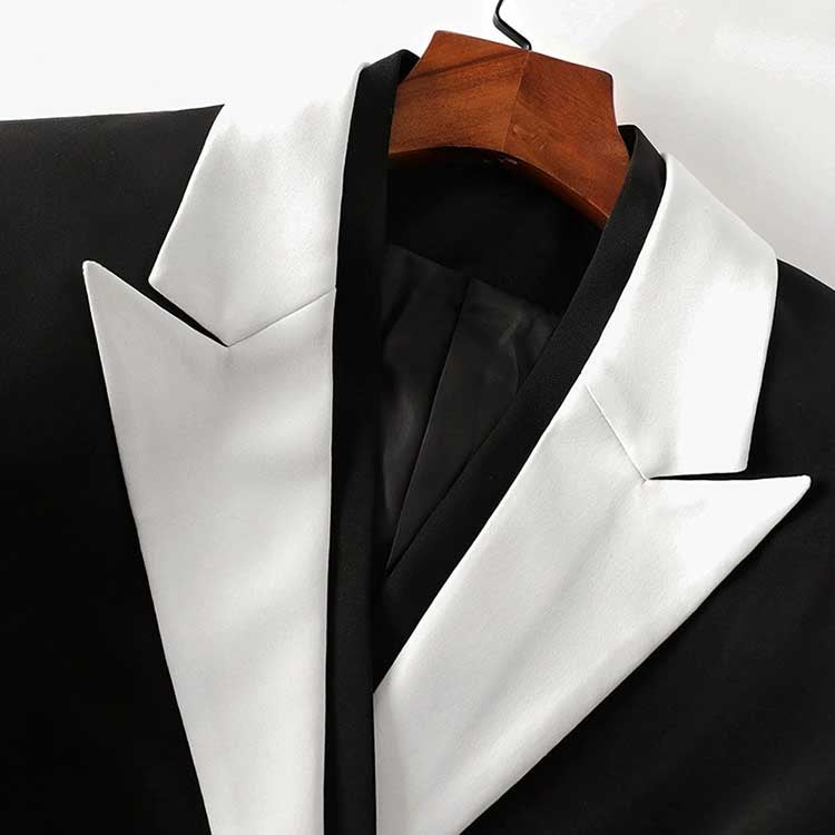 Back view of a black blazer with white collar for women featuring stylish buttoned sleeves