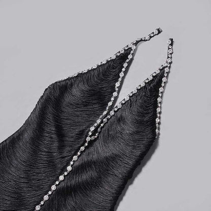 Close-up of a black halter neck rhinestone dress showcasing elegant straps with sparkling embellishments