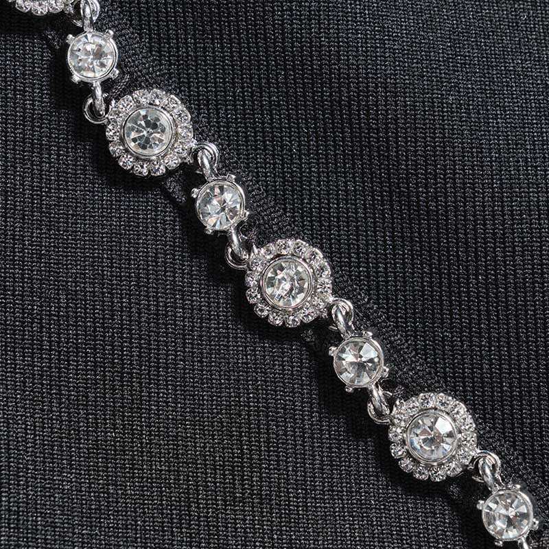 Close-up of the embellishments on a black halter neck rhinestone dress featuring sparkling rhinestones