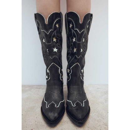 Black star embroidered cowboy boots with elegant stitching and unique design for style and comfort