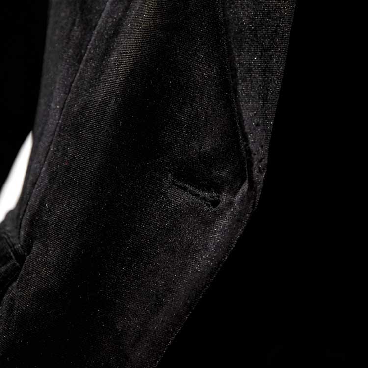 Close-up of a black velvet pantsuit for women showcasing soft fabric and tailored details