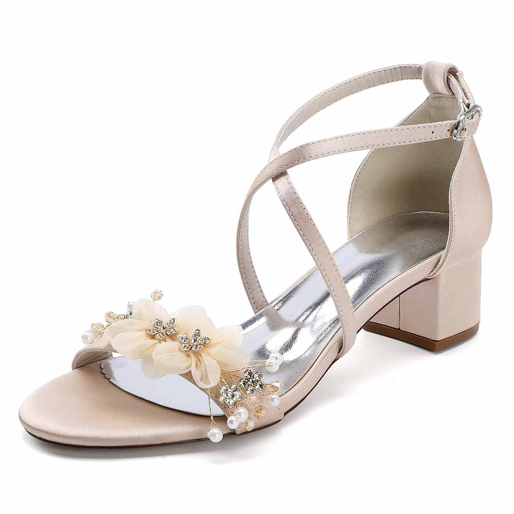 Elegant block heel wedding sandals with floral embellishments and crisscross straps for bridal elegance