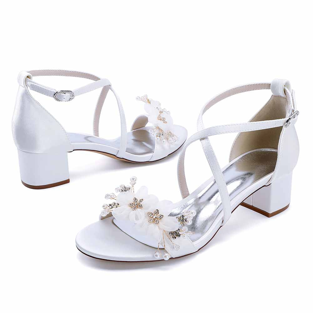 Elegant block heel wedding sandals with floral embellishments and adjustable ankle straps