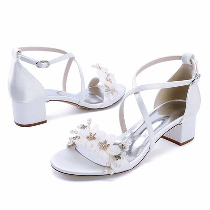 Elegant block heel wedding sandals with floral embellishments and adjustable ankle straps