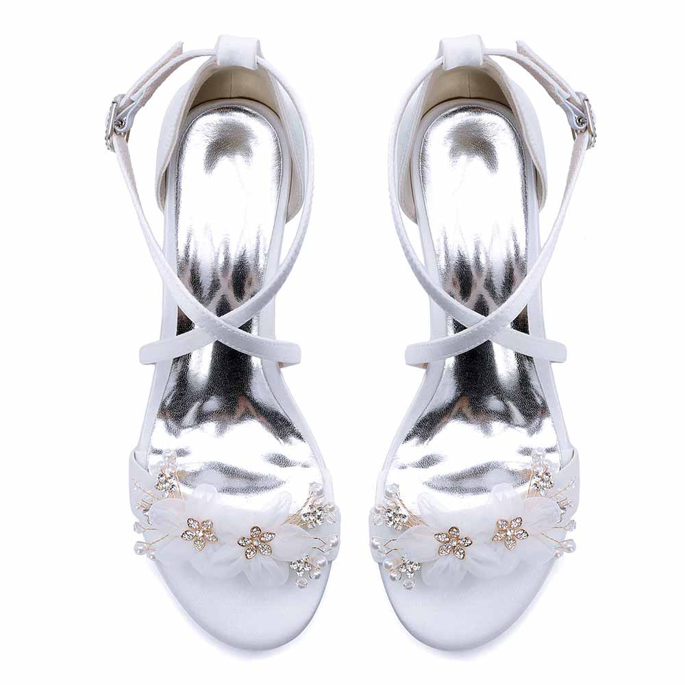 Elegant block heel wedding sandals with floral embellishments and shiny metallic straps