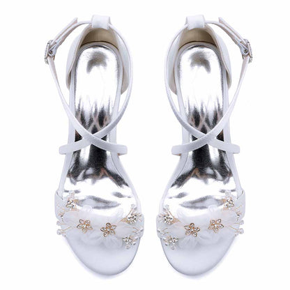 Elegant block heel wedding sandals with floral embellishments and shiny metallic straps