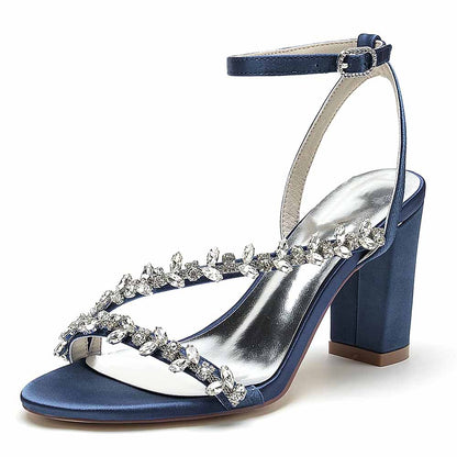 Elegant navy blue block heels sandals featuring crystal embellishments and ankle strap for stylish occasions