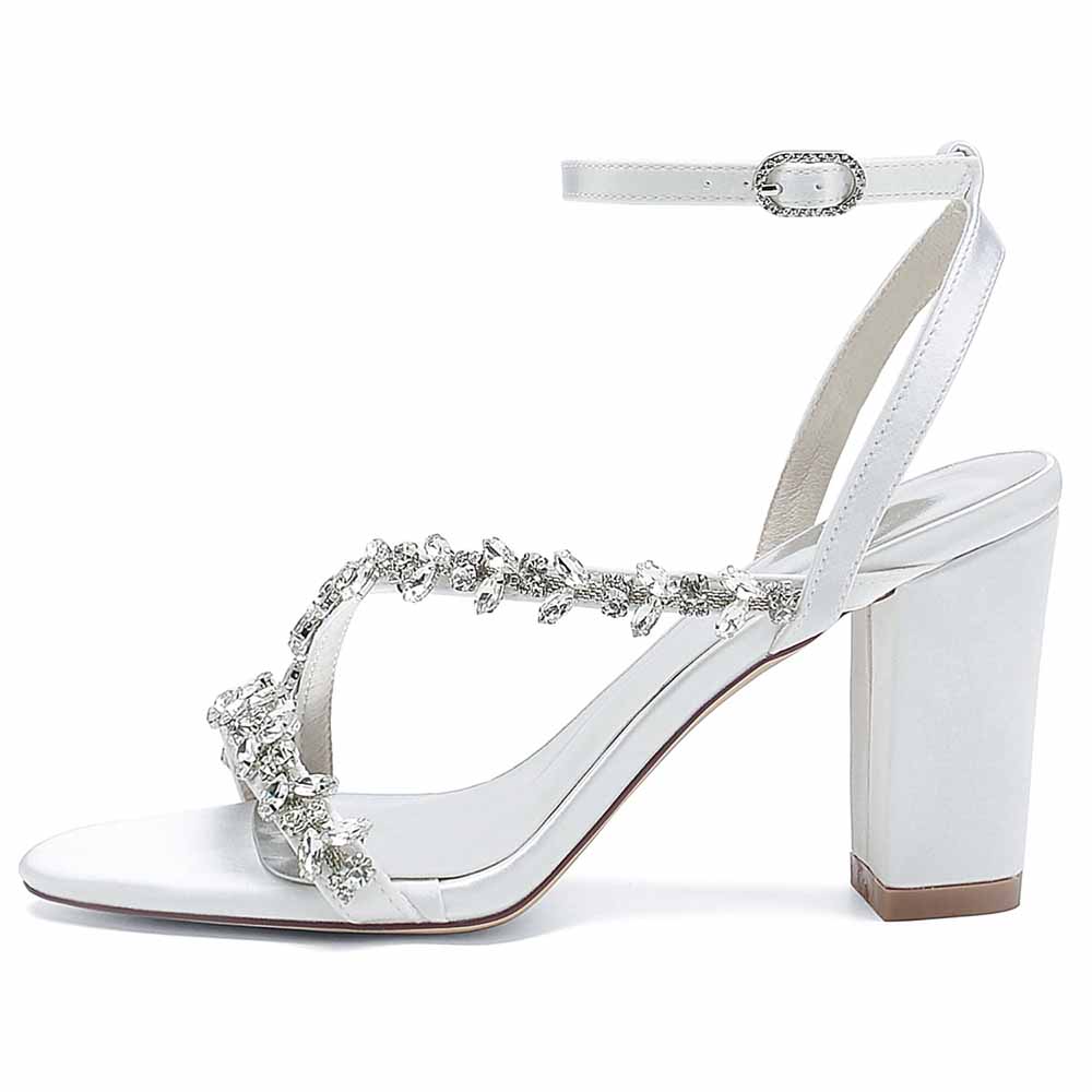 Elegant white block heels sandals with decorative embellishments and ankle strap for special occasions