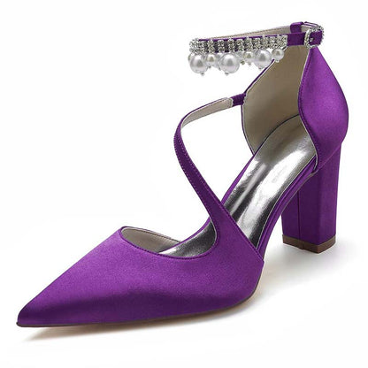 Purple high-heeled shoe with pearl embellishments on a white background