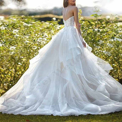 Stunning boho wedding dress with ruffles featuring a flowing skirt and delicate lace details