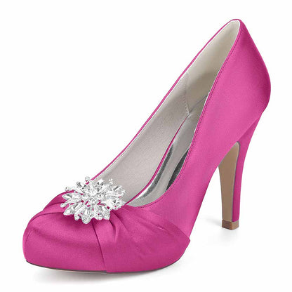 S&DCo. pink satin crystal embellished bridal heels featuring a decorative gem on the toe