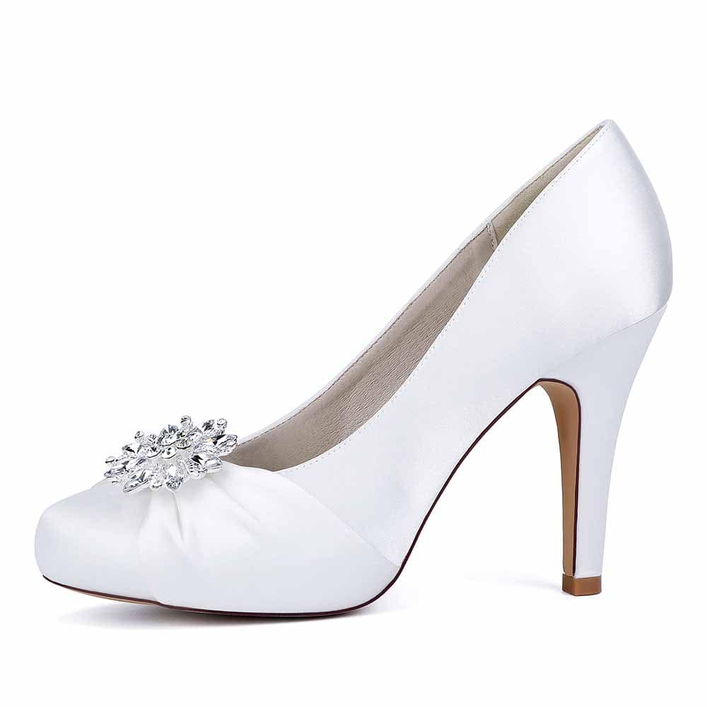 Elegant white crystal embellished bridal heels with a decorative floral accent and a sleek design