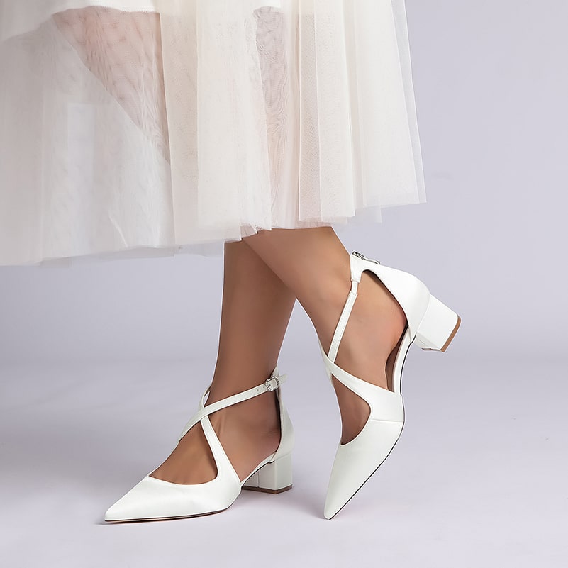 Elegant white bridal heels with crossing straps perfect for weddings and special occasions
