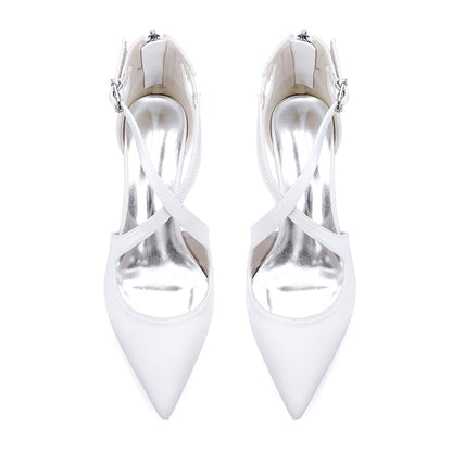 Elegant white bridal heels with crossing straps and pointed toes for wedding occasions