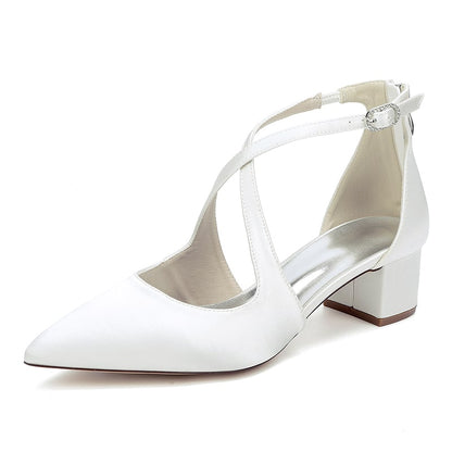 Elegant white bridal heels with crossing straps and a comfortable block heel for stylish weddings