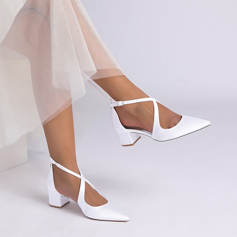 Elegant white bridal heels with crossing straps for a stylish wedding look