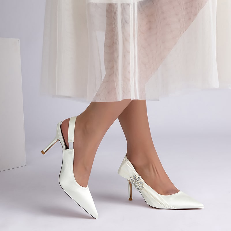 Elegant bridal heels with rhinestone embellishment, featuring a sleek design and stylish slingback detail.