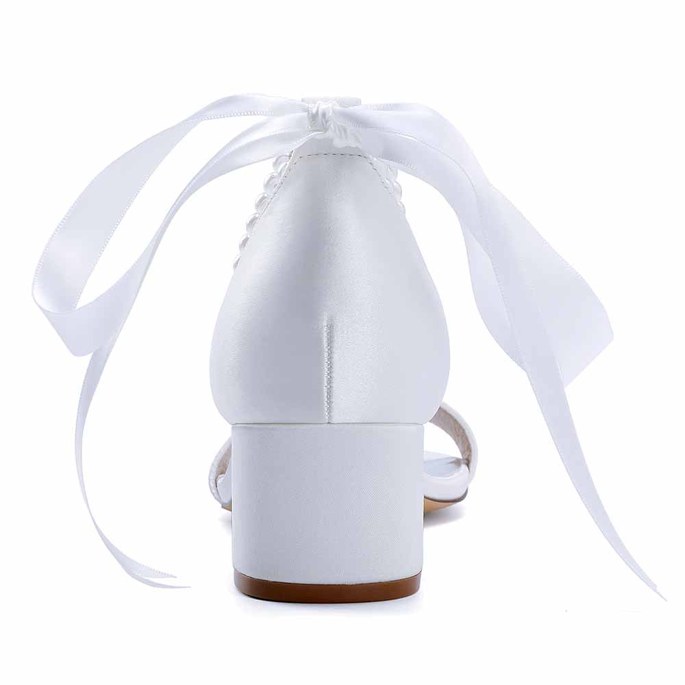 Elegant white lace-up dress sandals for brides with satin finish and decorative ribbon ties