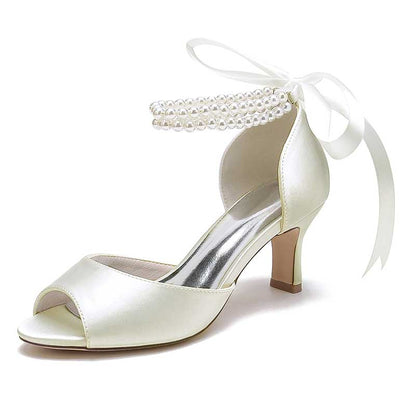 Elegant low heel satin bridal shoes with pearl ankle strap and bow detail for weddings