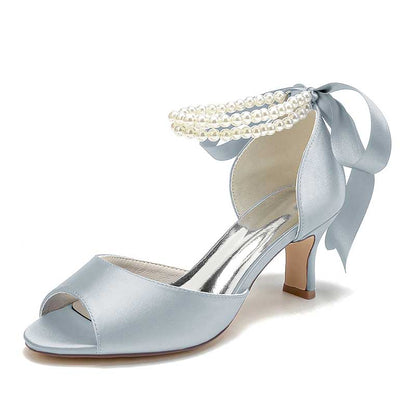 Elegant low heel satin bridal shoes in blue with pearl accents and a stylish bow