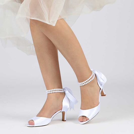 Elegant low heel satin bridal shoes by S&DCo with delicate ankle bows and pearl details