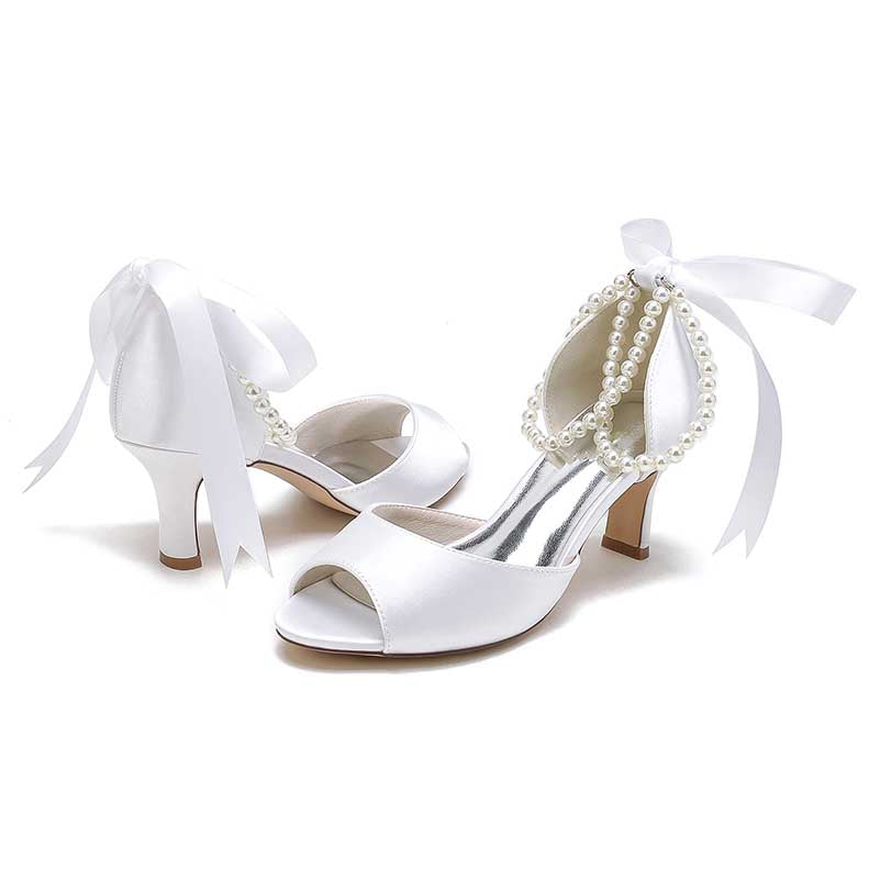 Elegant low heel satin bridal shoes with pearl accents and bow for a stylish wedding look