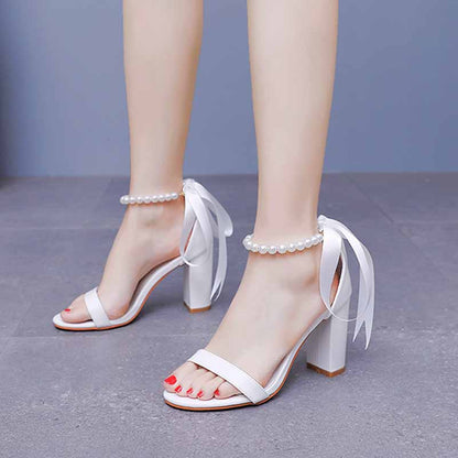 Elegant bridal pearl ankle strap chunky heels in white with ribbon ties for special occasions