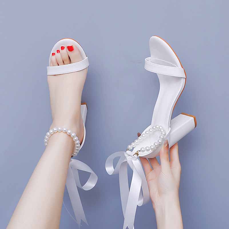 White bridal pearl ankle strap chunky heels with elegant ribbon details for stylish brides