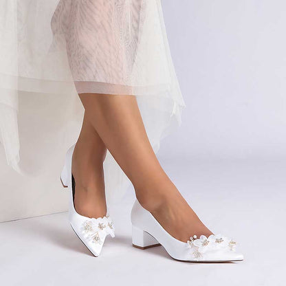 Elegant white bride shoes with flower appliques, perfect for bridal outfits and special occasions