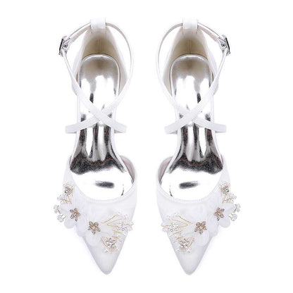 Elegant white heels as bridesmaid shoes with flower detail and ankle strap for special occasions