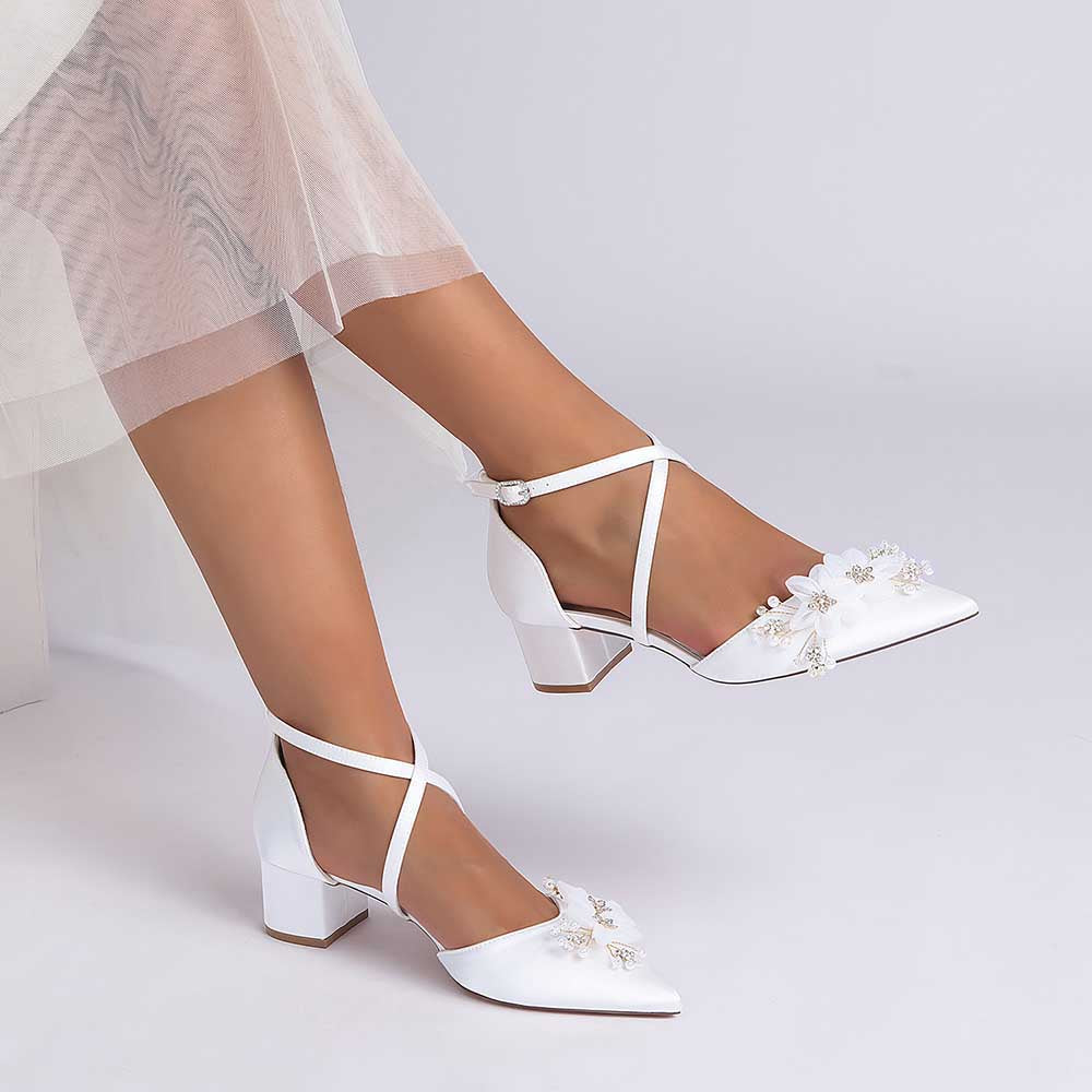 White bridesmaid shoes with flower detail and ankle strap for elegant wedding occasions