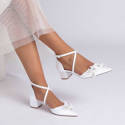 White bridesmaid shoes with flower detail and ankle strap for elegant wedding occasions