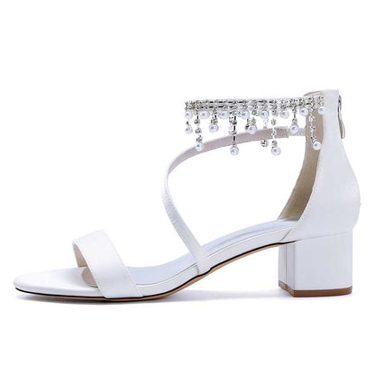 White chunky heel formal shoes with rhinestones featuring an elegant ankle design and a stylish block heel