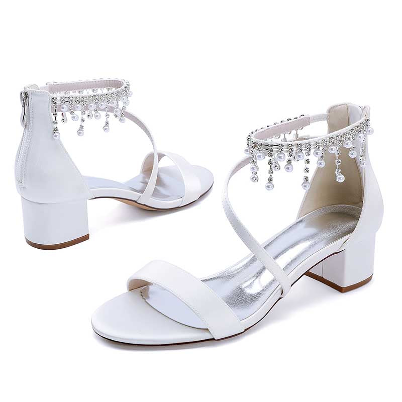White chunky heel formal shoes with rhinestones featuring elegant ankle strap design.