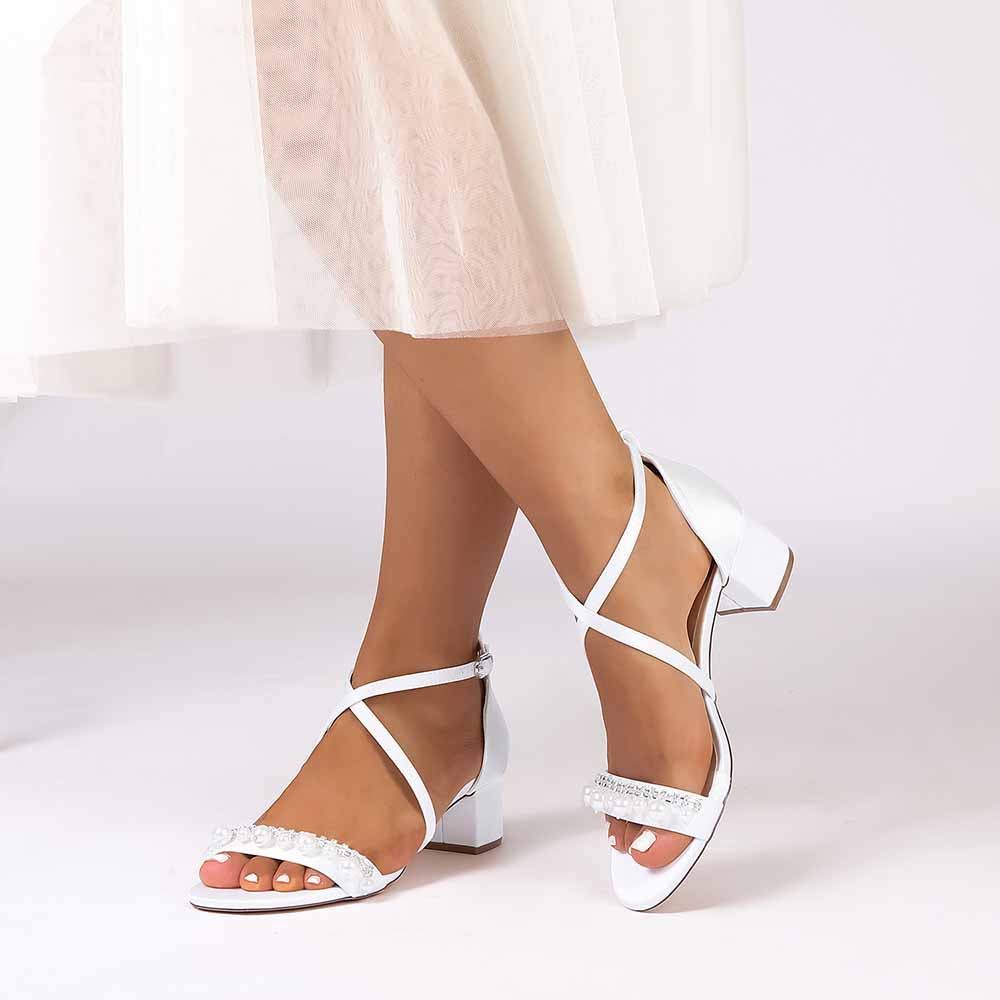 Elegant white chunky heel prom sandals with sparkling accents and crisscross straps for special occasions