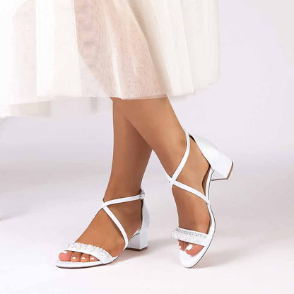 Elegant white chunky heel prom sandals with sparkling accents and crisscross straps for special occasions