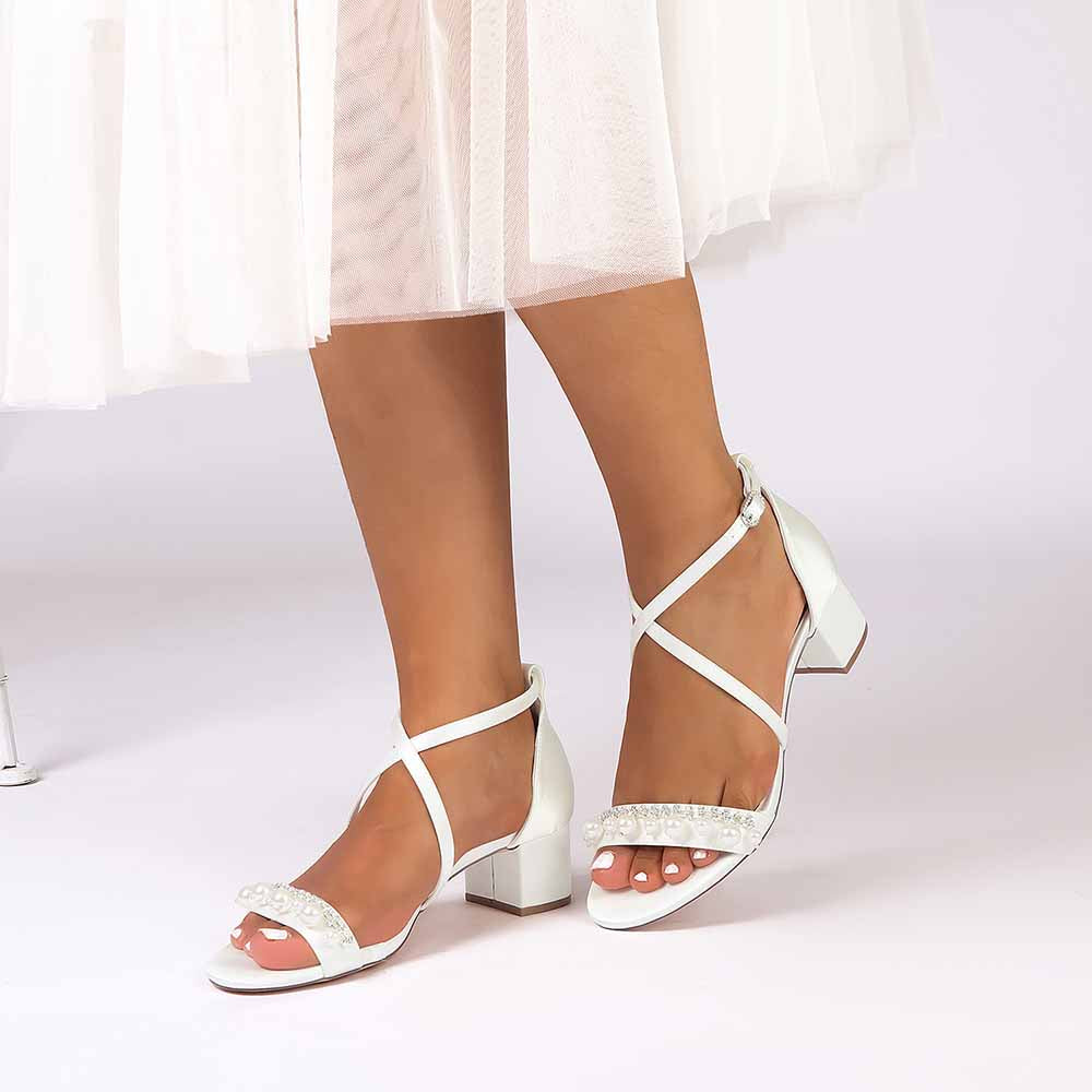 White chunky heel prom sandals with delicate straps and embellishments for elegant nights out