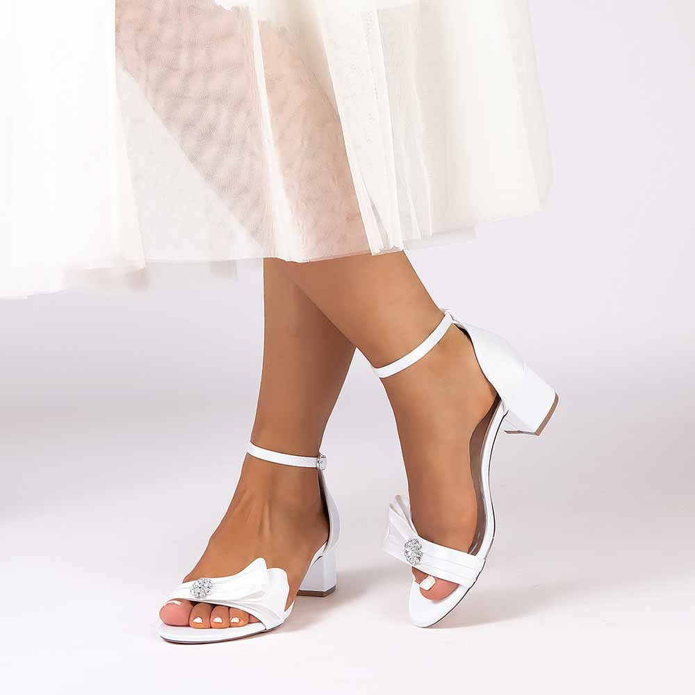 Elegant white chunky heel wedding sandals with bow and ankle strap for bridal style