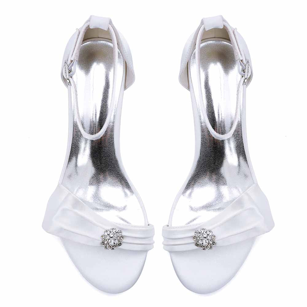 Elegant chunky heel wedding sandals in white with jeweled embellishment and sleek strap design