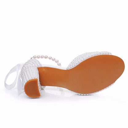 White chunky lace up bridal shoes with decorative pearls and elegant design for special occasions