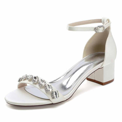 Elegant white low block heel dress sandals for wedding with sparkling embellishments and ankle strap