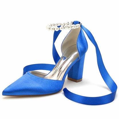 Closed toe lace up bridal shoes in blue satin with a decorative pearl ankle strap.