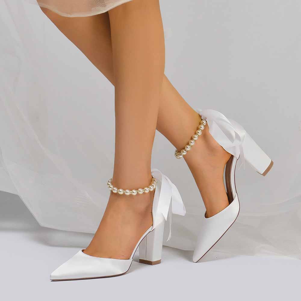 Closed toe lace up bridal shoes in white with elegant ribbon and pearl accents