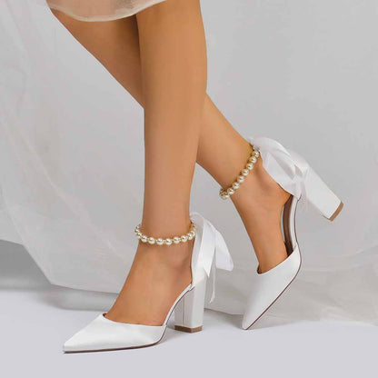 Closed toe lace up bridal shoes in white with elegant ribbon and pearl accents