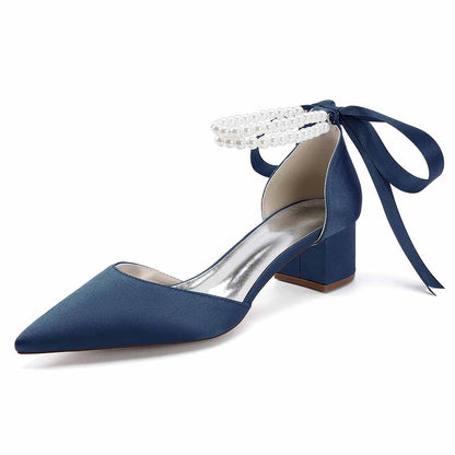 Elegant closed toe wedding heels for bride in navy blue with pearl ankle bow detail