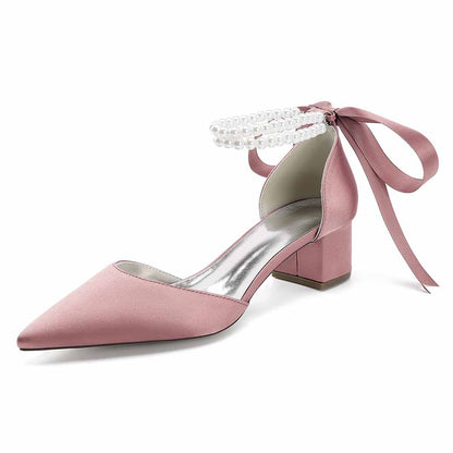 Elegant closed toe wedding heels for bride in soft pink satin with pearl ankle strap and bow detail