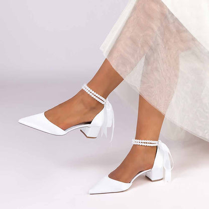 Elegant closed toe wedding heels for bride with ankle ribbon and pearl details, perfect for a stylish ceremony