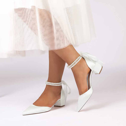 Elegant closed toe wedding heels for bride with bow detail and ankle strap for a chic look